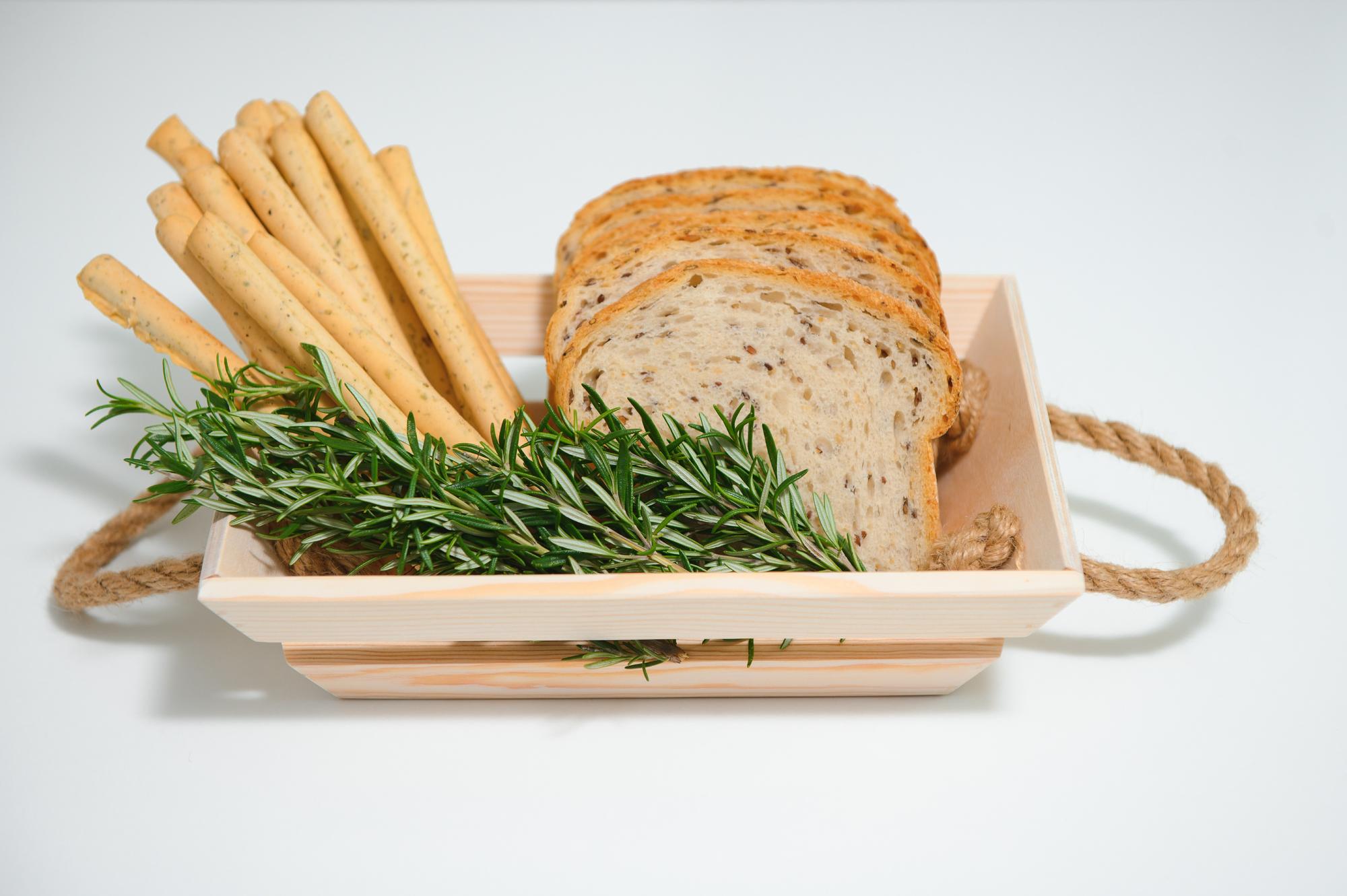 large still-life: loaf, herbs, and a cutting board